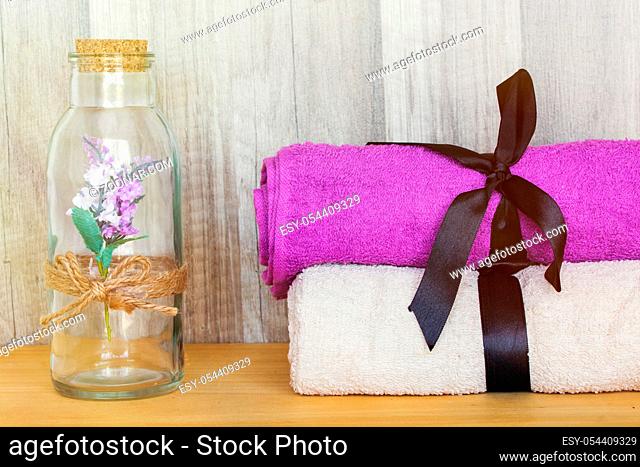 Closeup on Towels with decorative bottle. Beauty Spa Health and Wellness concept