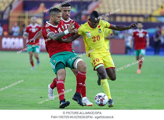 05 July 2019, Egypt, Cairo: Morocco's Manuel da Costa (L) and Nabil Dirar (C) battle for the ball with Benin's Jodel Dossou during the 2019 Africa Cup of...