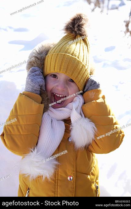 Little girl screaming, portrait, with bobble hat and scarf, 6 years old, in winter at snow, Karlovy Vary, Czech Republic, Europe