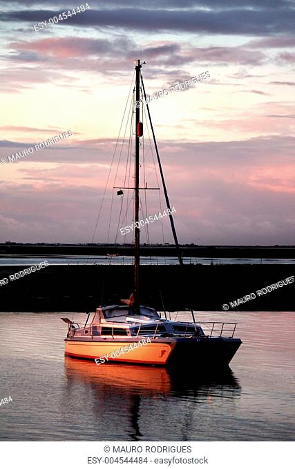 Anchored boat at sunset
