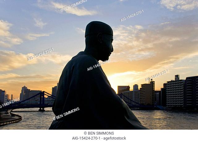 A statue of Matsuo Basho (Japan's most renowned haiku poet) overlooks the Sumida River and Kiyosubashi Bridge from the Basho-An Garden