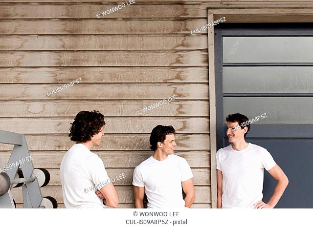 Men standing and chatting on front porch