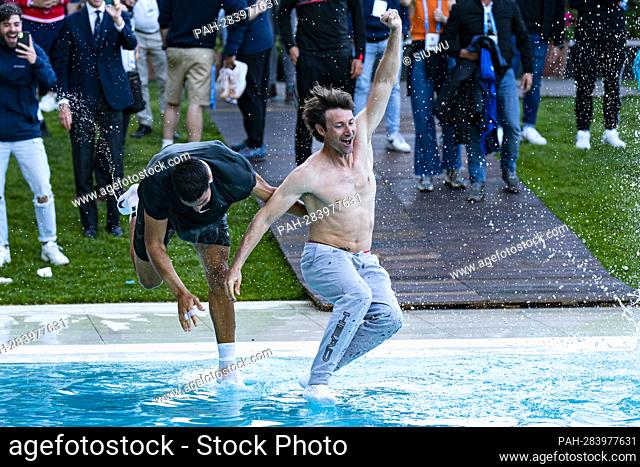 Carlos Alcaraz of Spain jump into the pool with his trainer Juan Carlos Ferrero following the Barcelona Open Banc Sabadell tennis match at the Real Club de...