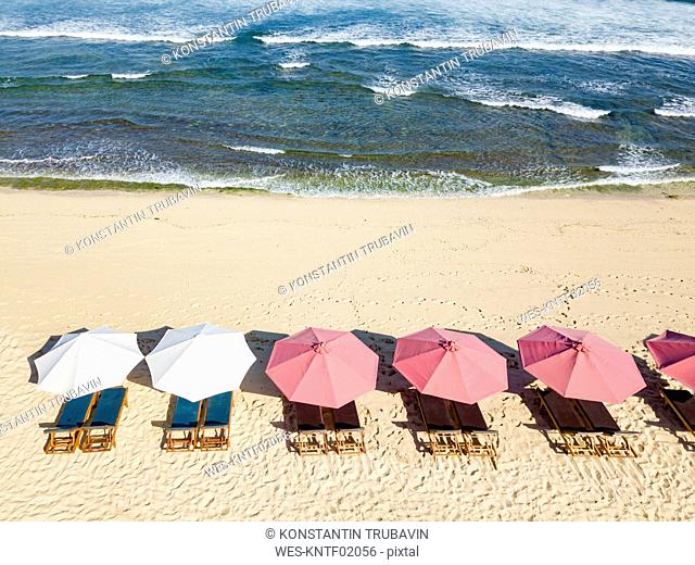 Indonesia, Bali, Aerial view of Balangan beach, sunloungers and beach umbrellas