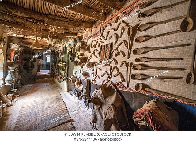 View down hallway of Muse de la Memoire Nomade with a variety of wooden spoons and other artifacts on display from Berber nomads, Tighmert Oasis, Morocco