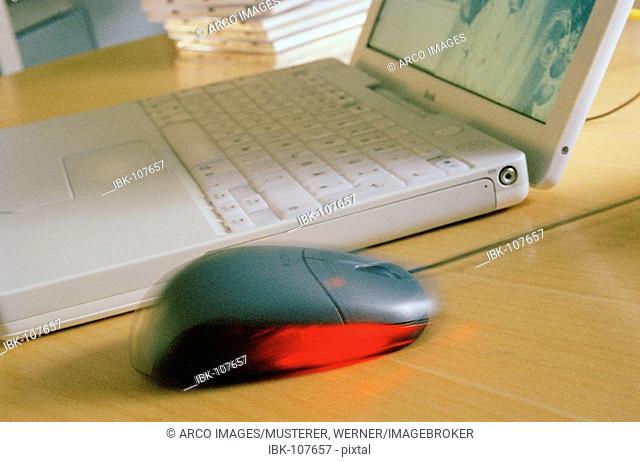 Optical mouse next to laptop