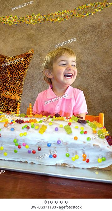 little boy with giant birthday cake