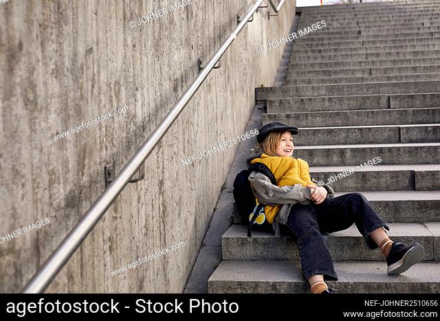 Smiling girl sitting on stairs