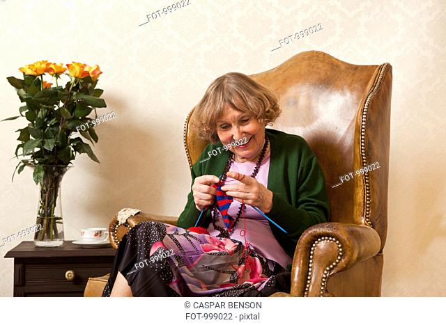 A senior woman enjoying knitting