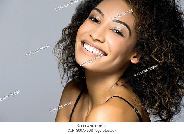 Studio portrait of beautiful happy young woman