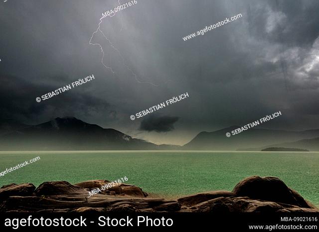 Storm on the shores of lake Walchensee with storm, lightning, rain and hail
