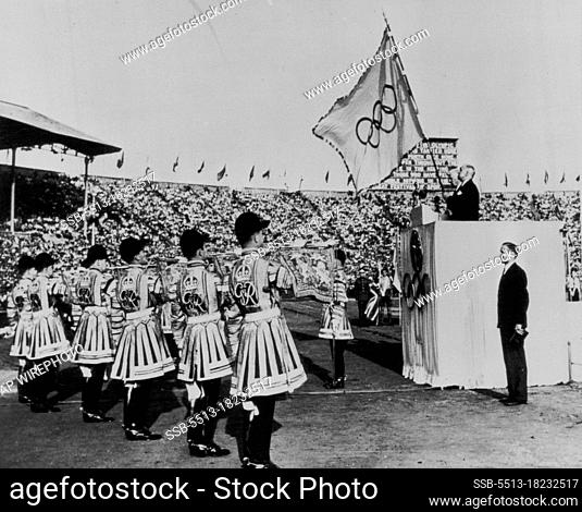 The XIV Olympiad Closed -- Sir Frederick Wells, lord mayor of London, holds the Olympic flag as the state trumpeters blare the official end of the fourteenth...