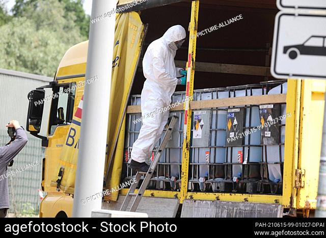 15 June 2021, Thuringia, Eisenberg: Police officers of the State Criminal Police Office secure traces on a hazardous goods truck on a parking lot of the highway...
