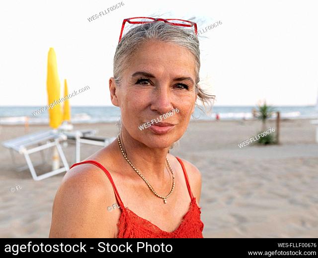 Senior woman with gray hair at beach