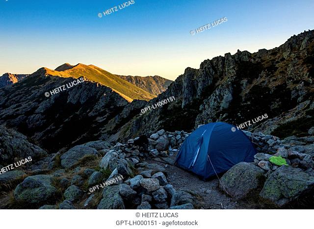 TENT IN A MOUNTAINOUS LANDSCAPE UNDER THE LAST LIGHT OF DAY, PETRA PIANA REFUGE, GR20 NORTH, CORSICA, FRANCE
