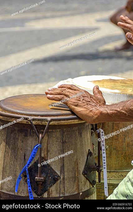 Percussionist playing a rudimentary atabaque during afro-brazilian cultural manifestation at Pelourinho on Salvador city, Bahia