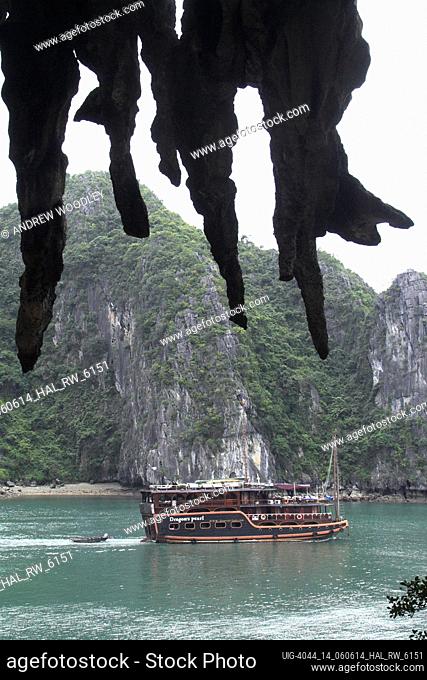 Stalactites in Hang Trong the Drum Grotto appear to hang over the Dragons Pearl cruising junk Halong Bay Vietnam