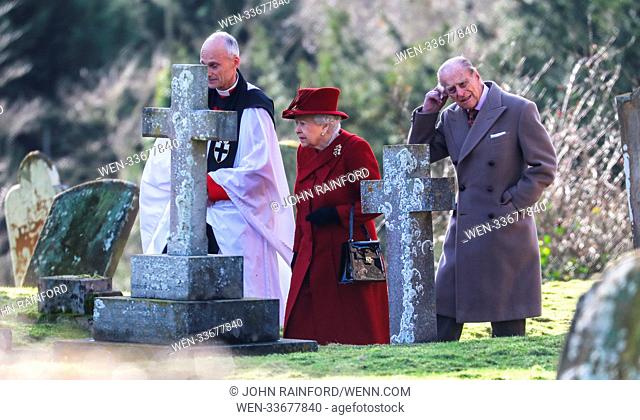 Queen Elizabeth, accompanied by the Duke of Edinburgh, attends morning service at St. Peter and St. Paul Church in West Newton, Norfolk