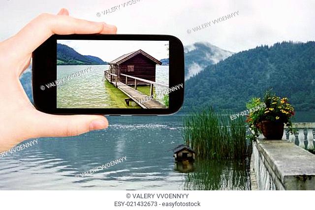 tourist taking photo of shed on Schliersee lake