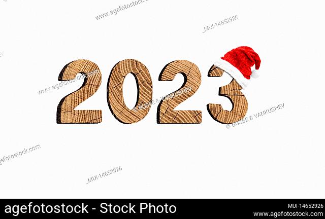 Year 2023 made of wood with red Christmas hat