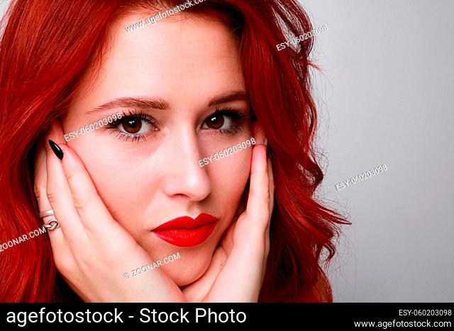 Portrait of sensual and attractive woman beautiful red hair posing over white background. Space for text. High quality photo