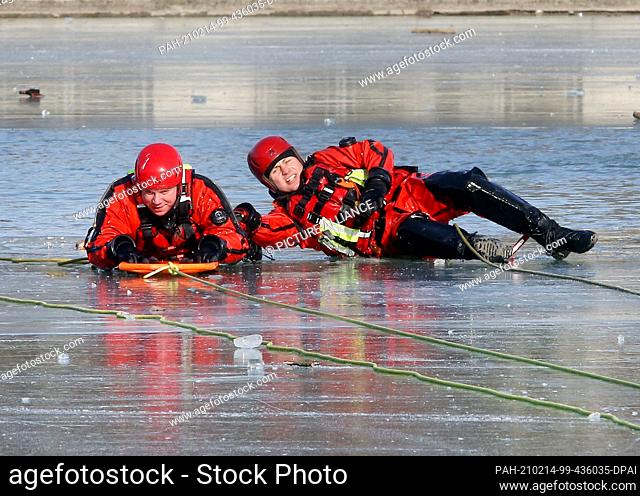 14 February 2021, North Rhine-Westphalia, Cologne: Firefighters practice ice rescue at the Aachen pond. The ""victim"" in this case is a fire brigade diver