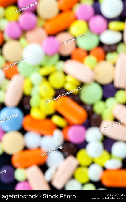 multicolored abstract background out of focus, made of different color pills used to treat patients, photo