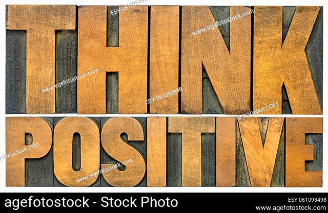 Think positive -isolated word abstract in vintage letterpress wood type blocks, optimism and mindset concept