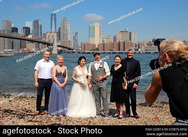 PRODUCTION - 02 August 2022, US, New York: Wedding planner Erol Inanc (2nd from right) stands together for a group photo on the sidelines of the wedding...