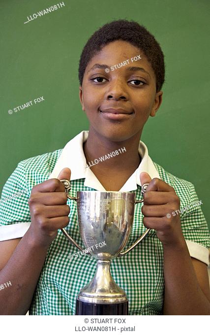Portrait of a schoolgirl holding her trophy, KwaZulu Natal Province, South Africa