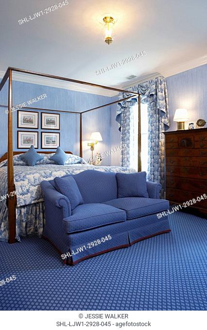 Master Bedrooms: Blue theme, blue wallpaper, blue and white draperies, w/swag valance, blue w/w carpet, tall chest of drawers, four poster bed