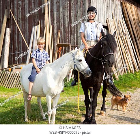 Germany, Bavaria, Mature woman and boy on horse