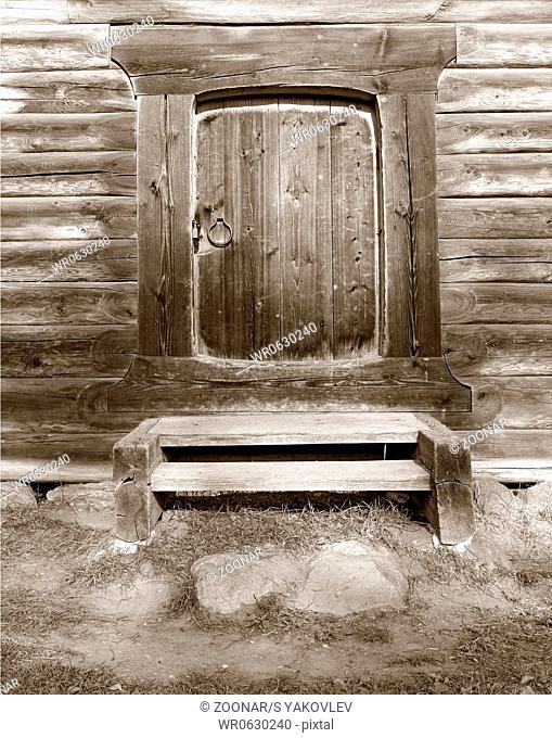 door in old wooden house, sepia
