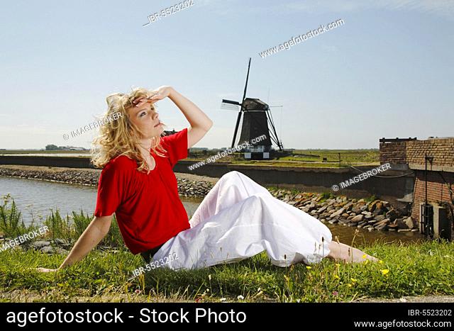 Woman looking at the sky, windmill 'De Bol', Het Noorden, Texel, Netherlands