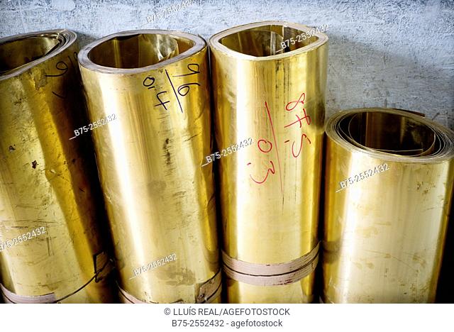 Brass rolls in a warehouse of metals in the medina of Fez, Morocco, Africa