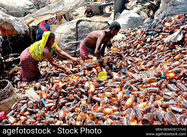 Locals are seen separating bottles of polyethylene terephthalate (PET) in a recycling factory on the outskirts of Dhaka. Recycling plastic bottles has become a...