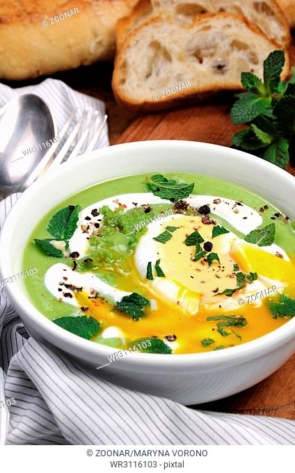 Pea puree soup with poached egg and peppermint
