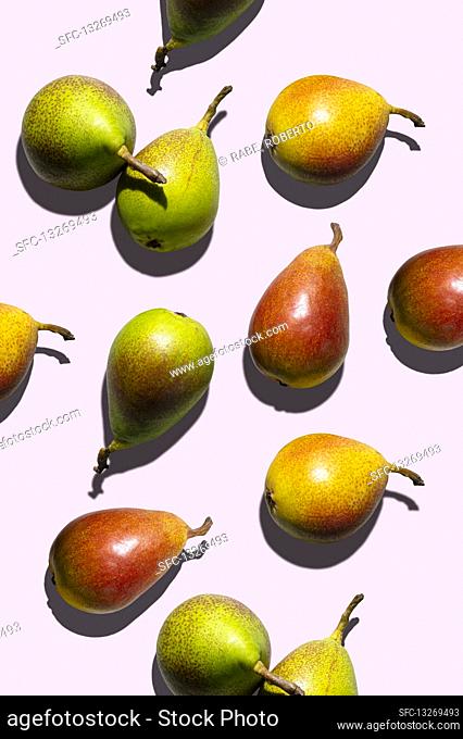 Different pears on a pink background