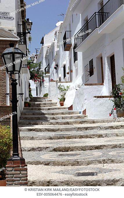 Small street in Andalusian mountain village Frigiliana, Spain