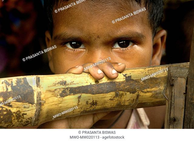 A child stares from their shack, at a slum in Dhapa, Kolkata, West Bengal, India October 18, 2008 Despite a robust economy with 9 percent annual growth in...