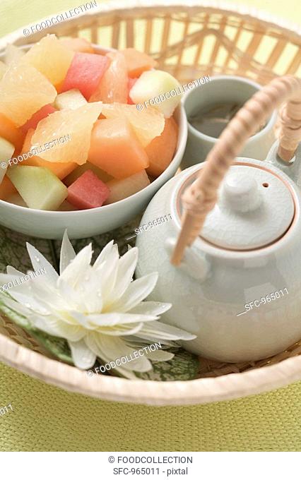 Fruit salad and tea in basket