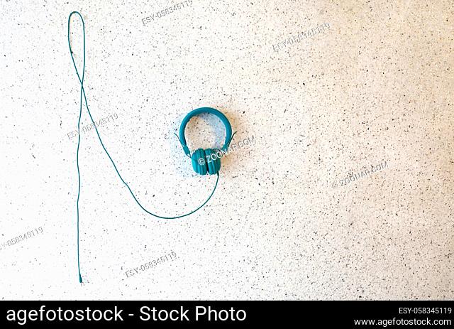 Wired headphones hanging at the wall