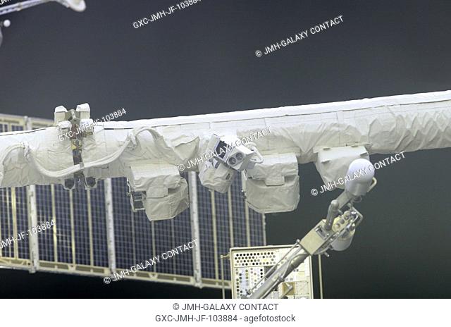 View of a segment of the Canadarm2 Space Station Remote Manipulator System (SSRMS, center), UHF antenna (bottom foreground)