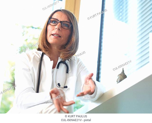 Doctor sitting at desk in office