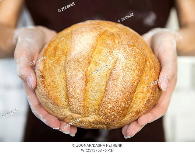 Fresh bread in female hands