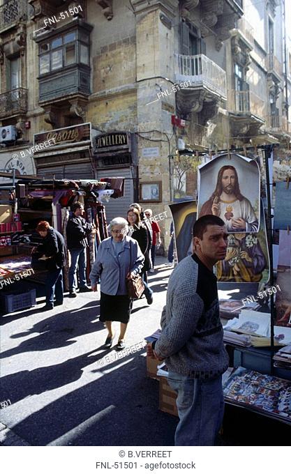 People in street, scene souvenir stand, Valletta, Malta