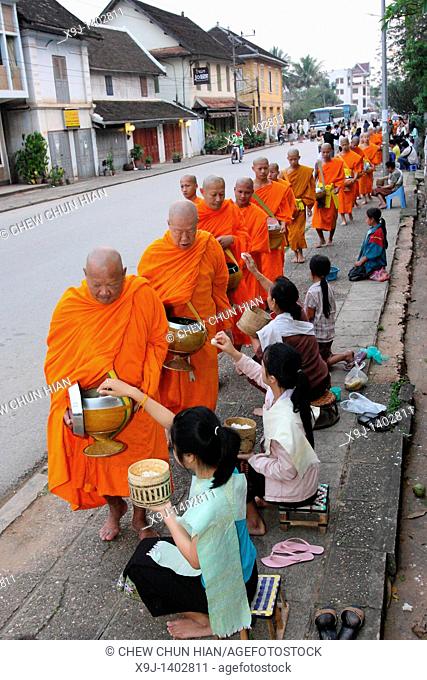 Morning round of buddhist monks begging for alms or Tak Bat, Luang Prabang, UNESCO World Heritage Site, Laos