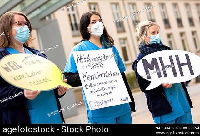15 April 2021, Lower Saxony, Hanover: Protest placards reading ""Because empty phrases don't save lives"", ""Inaction costs lives"" and ""MHH"" can be read...