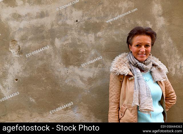 Portrait of mature beautiful Scandinavian tourist woman with short hair traveling around the city of Stockholm in Sweden