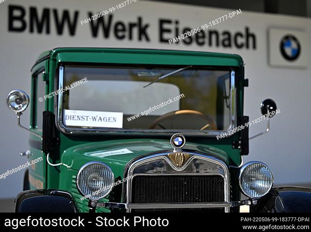 06 May 2022, Thuringia, Krauthausen: A historic BMW vehicle stands in front of the entrance to the BMW plant in Eisenach during the festive event
